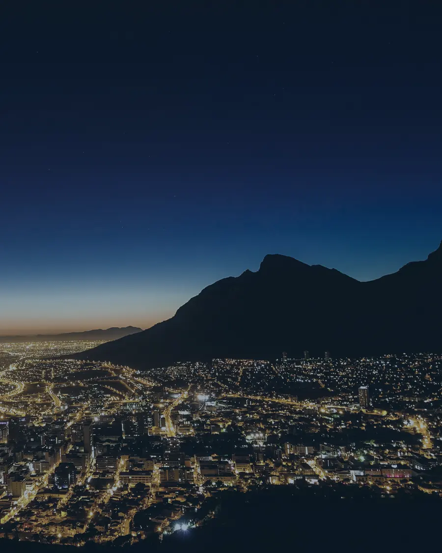 Table Mountain silhouette over the lights of Cape Town