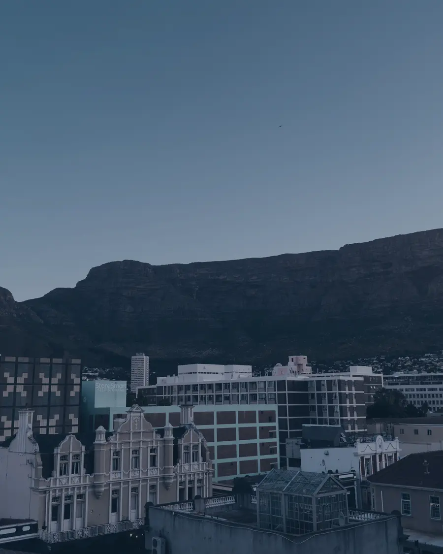 Victorian rooftops and city buildings below Table Mountain